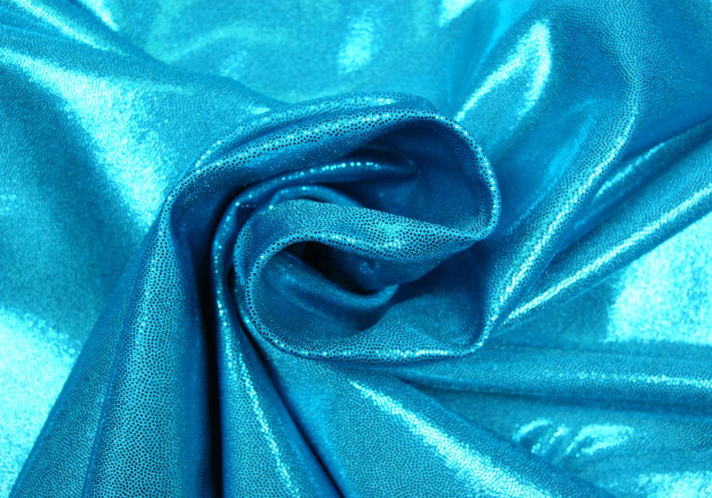 Glitterstof met stretch - Aquablauw Lycra